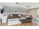 Cozy living room featuring a large sectional sofa, TV, and stylish decor, perfect for relaxation and entertainment at 1516 Jae Pl, Lakeland, FL 33803