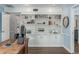 Home office boasts custom built-ins, a view of the front door, and wood floors at 1516 Jae Pl, Lakeland, FL 33803