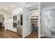 Well-stocked pantry with custom shelving and storage solutions, stainless appliances, and modern white cabinets at 1516 Jae Pl, Lakeland, FL 33803
