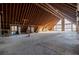 Unfinished attic featuring wood beams, concrete floor, and an abundance of natural light at 200 Lake Morton Dr # 100, Lakeland, FL 33801