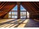 Unfinished attic featuring wood beams, concrete floor, and a lake view at 200 Lake Morton Dr # 100, Lakeland, FL 33801