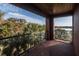 Charming outdoor balcony with glass railings, providing picturesque views of palm trees and a tranquil lake at 200 Lake Morton Dr # 100, Lakeland, FL 33801