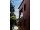 Detailed view of the red brick exterior, complemented by palm trees and blue skies at 200 Lake Morton Dr # 100, Lakeland, FL 33801