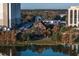Scenic view of the house on the water surrounded by trees and next to parking at 200 Lake Morton Dr # 100, Lakeland, FL 33801