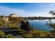 Scenic view of a calm lake reflecting the sky, surrounded by lush greenery and buildings in the distance at 200 Lake Morton Dr # 100, Lakeland, FL 33801