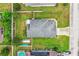 Overhead view shows a house with well-maintained lawn, fenced yard, and driveway at 2040 Chickadee St, Bartow, FL 33830