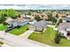 Aerial shot of the property, landscaped lawn, driveway, and neighboring homes at 2040 Chickadee St, Bartow, FL 33830