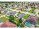Neighborhood view showing a home with a well-manicured lawn and mature trees at 2040 Chickadee St, Bartow, FL 33830