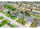 A high-angle shot showcases a community featuring homes with pools, solar panels, and landscaped yards at 2040 Chickadee St, Bartow, FL 33830