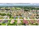 Scenic aerial shot of a neighborhood featuring a mix of houses with beautiful landscaping and mature trees at 2040 Chickadee St, Bartow, FL 33830