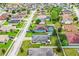 Aerial view of a neighborhood featuring homes with well-maintained lawns and mature trees at 2040 Chickadee St, Bartow, FL 33830