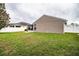 Exterior view of the home with a screened-in lanai and green backyard at 2040 Chickadee St, Bartow, FL 33830