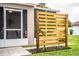 Backyard patio area with a modern wooden screen element and screened-in lanai at 2040 Chickadee St, Bartow, FL 33830