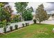 Well-maintained backyard featuring green lawn, white vinyl fence, and neatly arranged landscaping at 2040 Chickadee St, Bartow, FL 33830