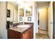 Bathroom featuring vanity with a sink with view to hall and open door to the shower/tub at 2040 Chickadee St, Bartow, FL 33830