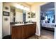Bathroom with a double sink vanity and a view into the adjacent bedroom at 2040 Chickadee St, Bartow, FL 33830