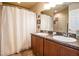 Bathroom featuring double sinks with a shower/tub combo with a privacy curtain at 2040 Chickadee St, Bartow, FL 33830