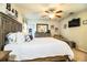 Well-lit bedroom featuring a bed, dresser, TV, and seating area for added comfort at 2040 Chickadee St, Bartow, FL 33830