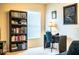 This bedroom features a desk, bookshelf, window, and neutral carpeting at 2040 Chickadee St, Bartow, FL 33830
