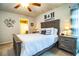 Comfortable bedroom with neutral tones, ceiling fan, and a decorative headboard at 2040 Chickadee St, Bartow, FL 33830