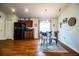 Dining room with modern chandelier, black refrigerator, and views of the decor at 2040 Chickadee St, Bartow, FL 33830