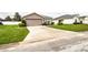 Property exterior with a spacious driveway, tidy landscaping, and well-manicured lawn at 2040 Chickadee St, Bartow, FL 33830