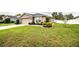 Home exterior with a well-manicured lawn and landscaped garden beds at 2040 Chickadee St, Bartow, FL 33830