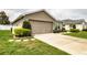 Charming home exterior featuring a well-maintained lawn and a two-car garage at 2040 Chickadee St, Bartow, FL 33830