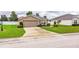 A cozy home with a two-car garage, neat landscaping, and a welcoming front entrance at 2040 Chickadee St, Bartow, FL 33830
