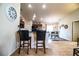 View of the kitchen bar with black stools and dining room at 2040 Chickadee St, Bartow, FL 33830