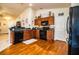 View of the eat-in kitchen with wooden cabinets, backsplash, and black appliances at 2040 Chickadee St, Bartow, FL 33830