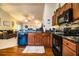 Well-lit kitchen with wood cabinets, black appliances, and an open view to the living room at 2040 Chickadee St, Bartow, FL 33830