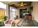 Relaxing covered lanai featuring comfortable seating, ceiling fan, and views of the surrounding landscape at 2040 Chickadee St, Bartow, FL 33830