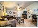 Spacious living room features neutral carpet, ceiling fan, cozy seating, and stylish decor at 2040 Chickadee St, Bartow, FL 33830