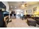 Bright living room with a ceiling fan and a glimpse of the open-concept kitchen and dining areas at 2040 Chickadee St, Bartow, FL 33830