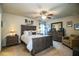 Spacious bedroom with ceiling fan, neutral colors, carpet, and well-lit lamps at 2040 Chickadee St, Bartow, FL 33830