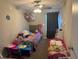A bedroom featuring a bed, nightstand, and a ceiling fan with lights at 208 Center St, Auburndale, FL 33823