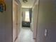 Long narrow hallway with painted walls and neutral-colored tile flooring at 208 Center St, Auburndale, FL 33823