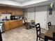 Functional kitchen with wooden cabinets, a stainless-steel dishwasher and tile flooring at 208 Center St, Auburndale, FL 33823