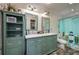 Bathroom featuring double sinks, ample cabinet storage, and a fun surfboard shower curtain at 2219 New Jersey Rd, Lakeland, FL 33803