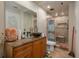 Bathroom featuring granite counter, vessel sink, a tiled shower with a built-in seat and modern fixtures at 2219 New Jersey Rd, Lakeland, FL 33803