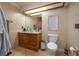 Cozy bathroom featuring vanity sink, toilet, and framed mirror above at 2219 New Jersey Rd, Lakeland, FL 33803