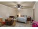 Cozy bedroom featuring tile floors, ceiling fan, and relaxed atmosphere, ideal for unwinding at 2219 New Jersey Rd, Lakeland, FL 33803