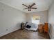 A cozy bedroom featuring a ceiling fan and a bright window, providing natural light at 2219 New Jersey Rd, Lakeland, FL 33803