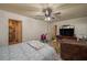 Inviting bedroom showing a ceiling fan and doorway to the bathroom at 2219 New Jersey Rd, Lakeland, FL 33803