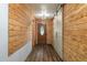 Rustic entryway with wood paneling and flooring, accented by modern light fixtures and a barn door at 2219 New Jersey Rd, Lakeland, FL 33803