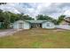 Quaint single-story home featuring a green metal roof and spacious front yard ready for landscaping at 2219 New Jersey Rd, Lakeland, FL 33803