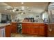 Kitchen island featuring wooden cabinets, wine cooler, ample counter space, and modern appliances at 2219 New Jersey Rd, Lakeland, FL 33803