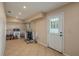 Bright laundry room with tile floors, utility appliances, and exterior door at 2219 New Jersey Rd, Lakeland, FL 33803
