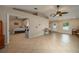Open-concept living area with neutral tones, ceiling fan, and tile flooring at 2219 New Jersey Rd, Lakeland, FL 33803